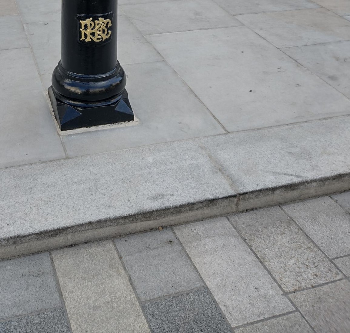 This is a photo of kerbs along a road paved in granite.