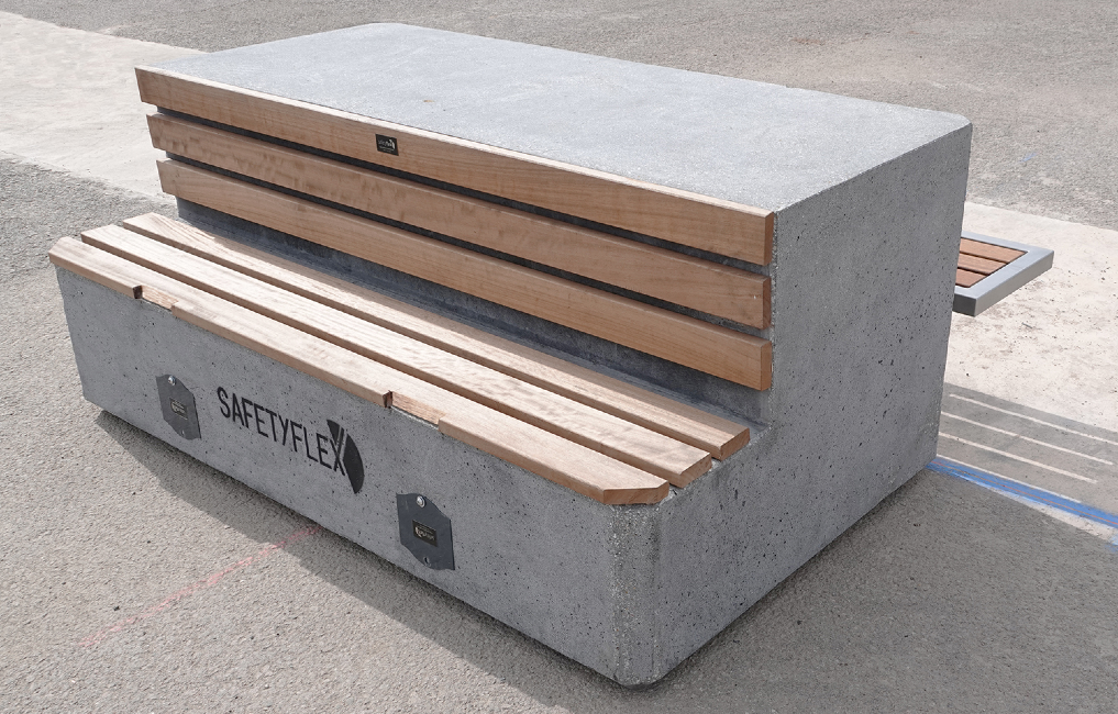 This is a photo of bulky concrete benches used to stop vehicles in pedestrian areas.