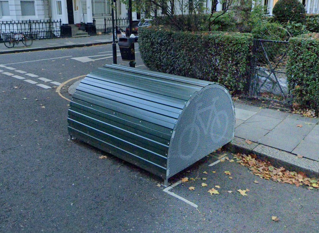 A green bicycle hangar at the kerbside